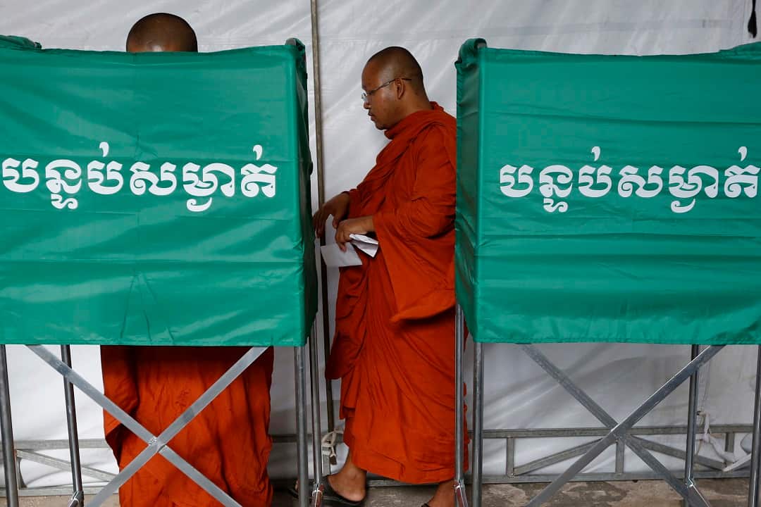 Cambodian Buddhist monks vote at a polling station in Phnom Penh.
