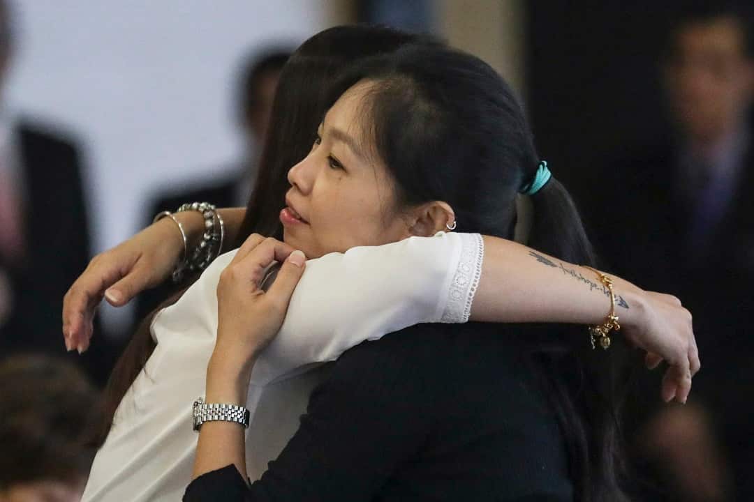 Next of kin of passengers on Malaysia Airlines flight MH370, hug at ministry of transport headquarters in Putrajaya.