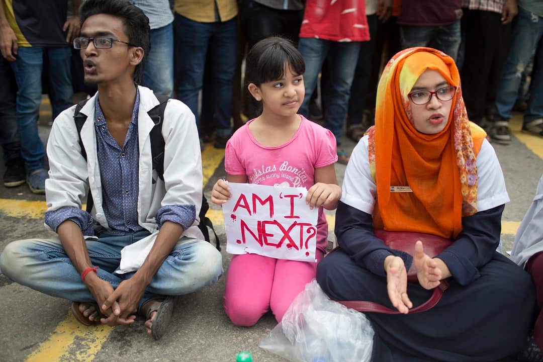 A Bangladeshi child holds a placard, as she participates with protesting students in Dhaka.