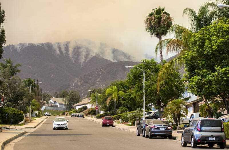 The "Holy Fire" burns near homes in Horsethief Canyon in Corona, Calif., on Wednesday, Aug. 8, 2018.