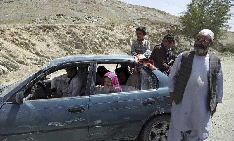 An Afghan family, who have escaped from the volatile Ghazni province, stop at a checkpoint in Maidan Shar, west of Kabul, Afghanistan, Monday, Aug. 13, 2018. 