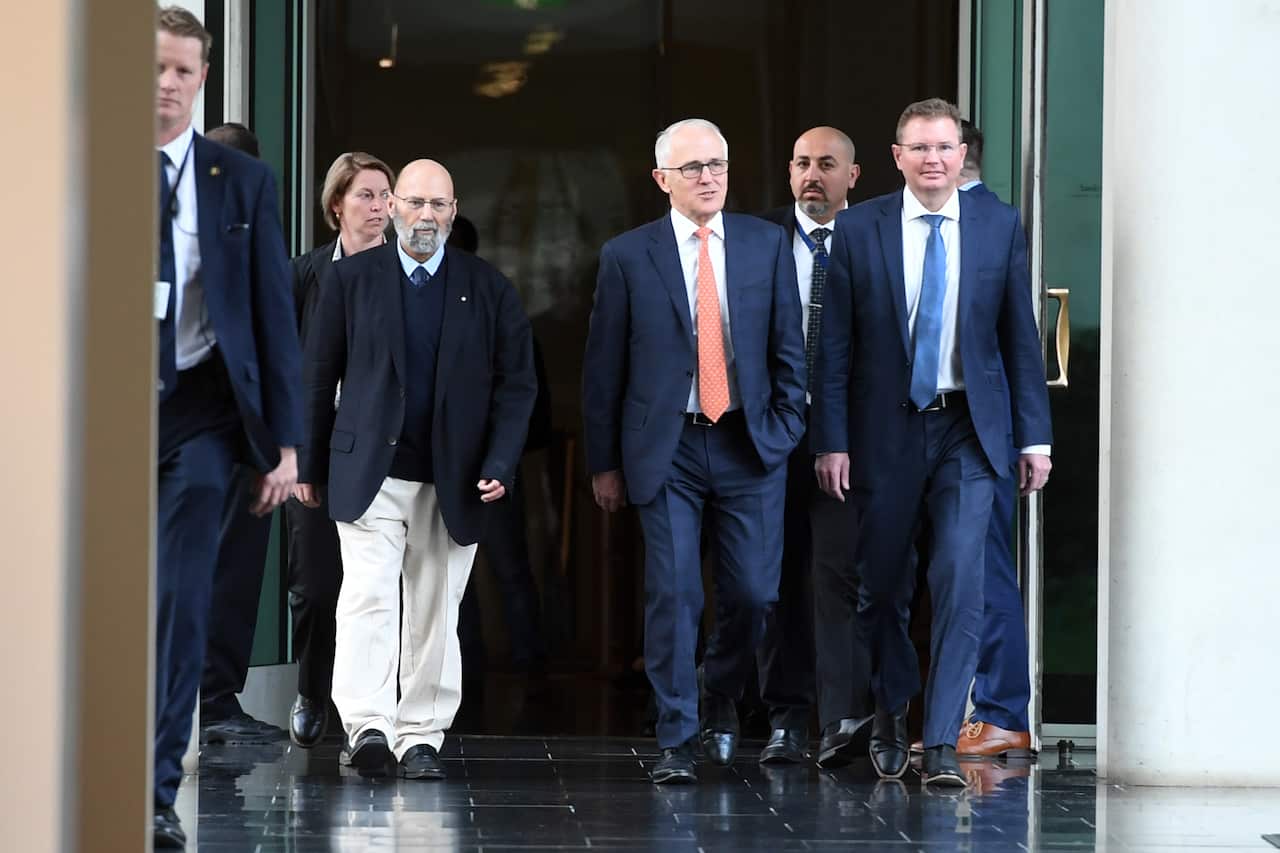 Malcolm Turnbull arrives with Arthur Sinodinos and Craig Laundy for the Liberal Party room meeting at Parliament House in Canberra, Friday, August 24, 2018.