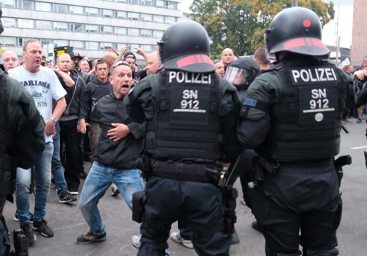 Police officers try to prevent a clash between right and left groups during the rally.