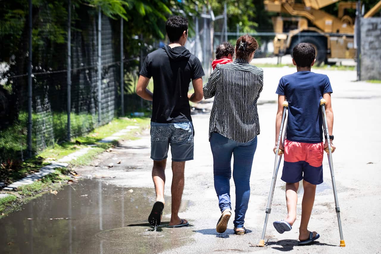 Refugees Mohammad, 17, Aryana, 2 1/2 months old, his mother and little brother Amirparsa, 11, are pictured on Nauru. 