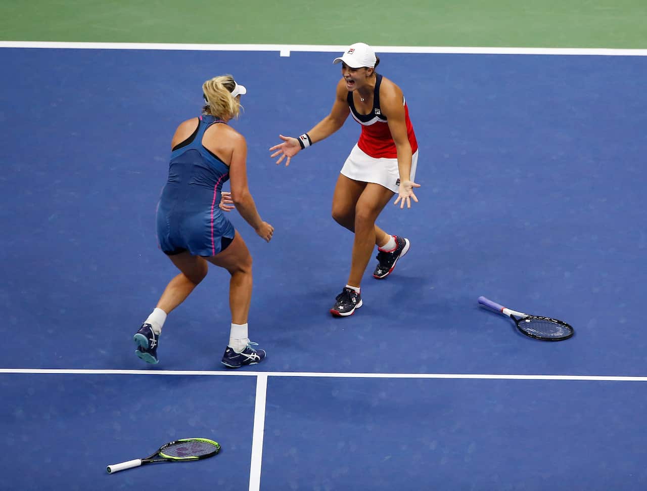 CoCo Vandeweghe and Ashleigh Barty, of Australia, celebrate after defeating Timea Babos, of Hungary, and Kristina Mladenovic, of France.