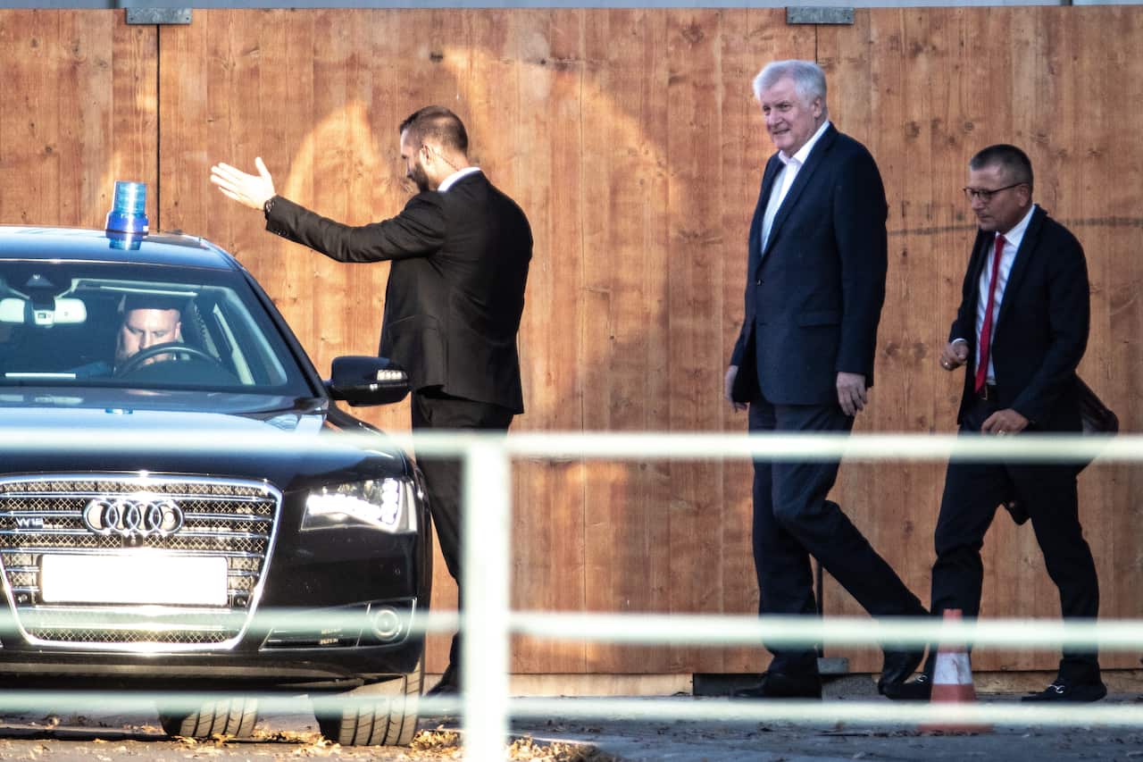 German Interior Minister Horst Seehofer leaves the Chancellery after meeting with leaders of coalition parties in Berlin, Germany.