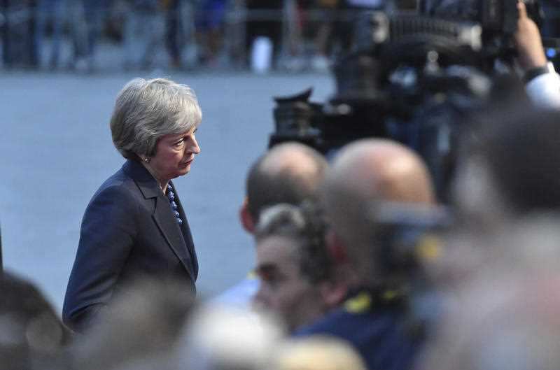 British Prime Minister Theresa May answers questions when arriving at the informal EU summit in Salzburg, Austria.