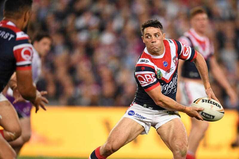 Cooper Cronk of the Roosters off loads the ball during the 2018 NRL Grand Final between the Sydney Roosters and the Melbourne Storm at ANZ Stadium in Sydney, Sunday, September 30, 2018.
