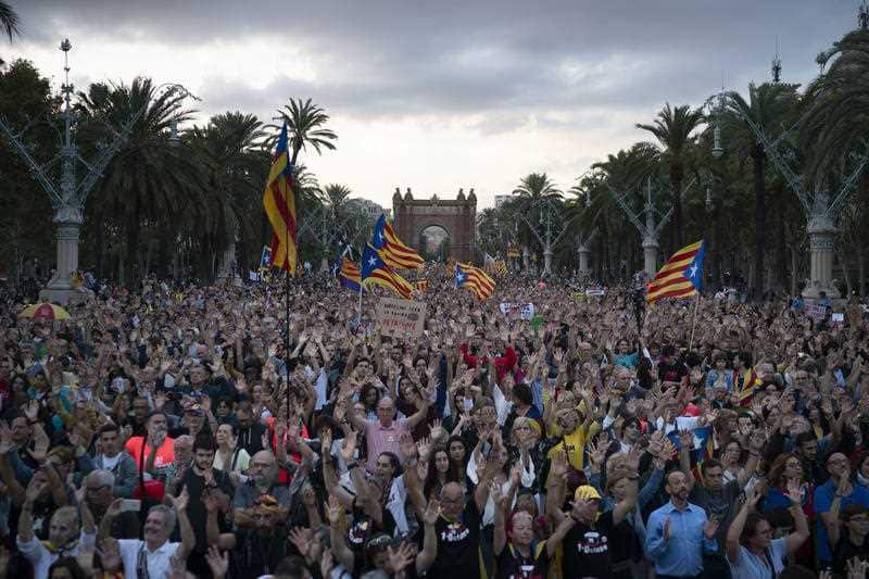 Hundreds of Pro independence demonstrators march during a protest for the anniversary of the banned referendum in Barcelona, Spain, Monday, Oct. 1, 2018.