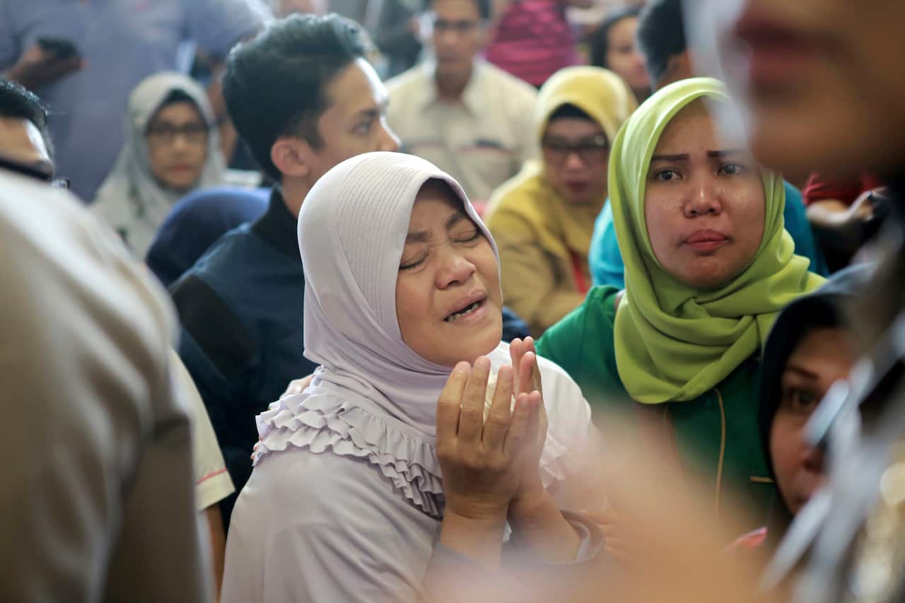 A relative of passengers prays as she and others wait for news on the Lion Air plane that crashed off Java Island.