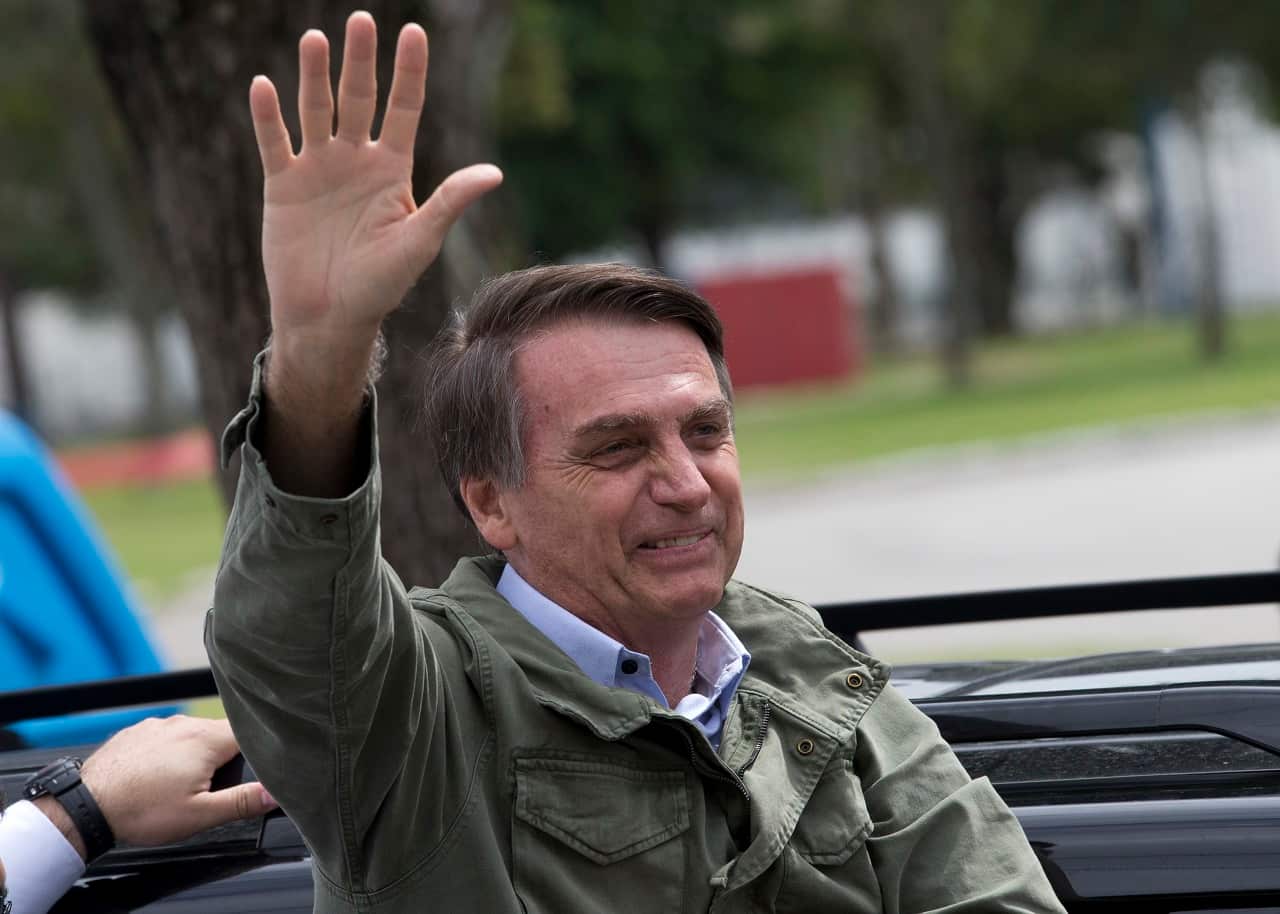Jair Bolsonaro waves to supporters.