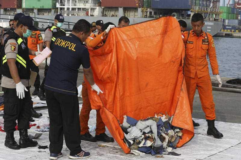 Officials unload pieces of wreckage recovered from the crashed Lion Air jet for further investigation at Tanjung Priok Port in Jakarta, Indonesia.