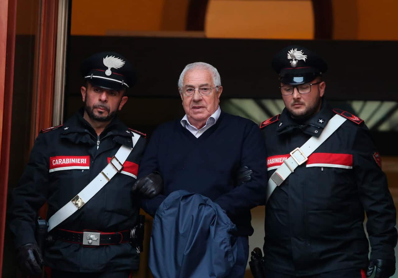 Settimino Mineo, center, who allegedly took over as the Palermo head of Cosa Nostra, is escorted by Italian Carabinieri police after an anti Mafia operation which led the arrest of 46 people.