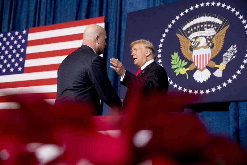 President Donald Trump shakes hands with acting United States Attorney General Matt Whitaker.