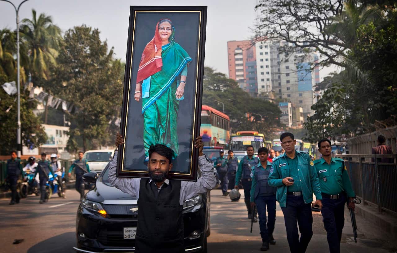 A Bangladeshi carries a giant photograph of Bangladesh Prime Minister Sheikh Hasina.