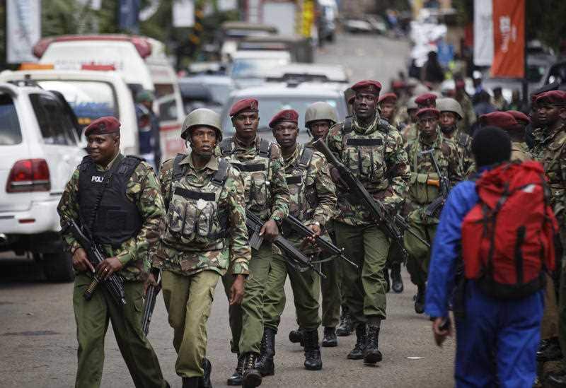 Kenyan security forces walk from the scene of the hotel attack.