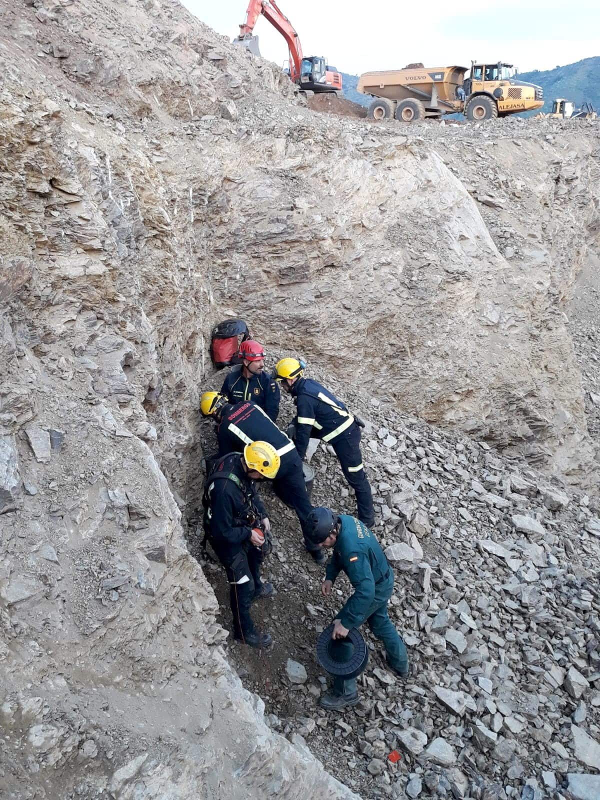 Firefighters and Civil Guard officers try to reach the two-year-old boy trapped in a well.
