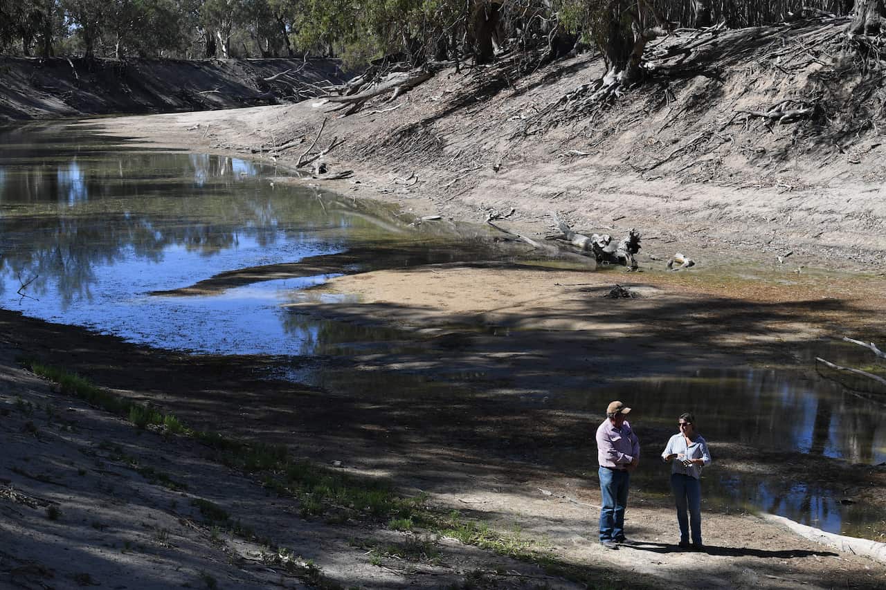 Farmers at the river bed of the depleted Lower Darling River at Pooncarie, NSW.