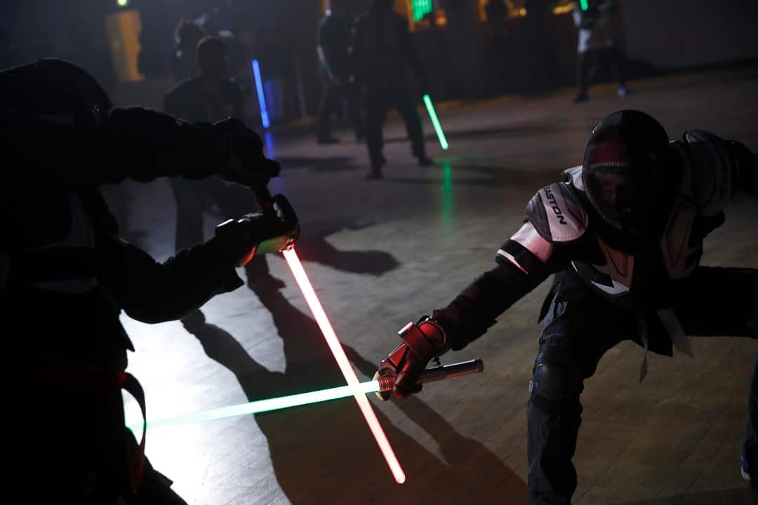 In this Sunday, Feb. 10, 2019, photo, competitors battle during a national lightsaber tournament in Beaumont-sur-Oise, north of Paris.