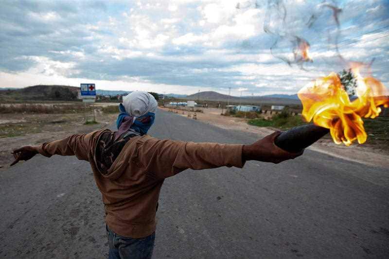 Opponents of Venezuelan President Nicolas Maduro clash with members of the Bolivarian National Guard of Venezuela