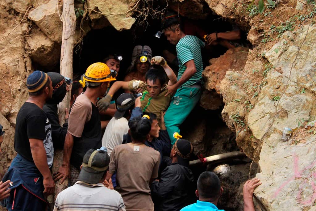 A survivor is carried out by rescuers in North Sulawesi Indonesia