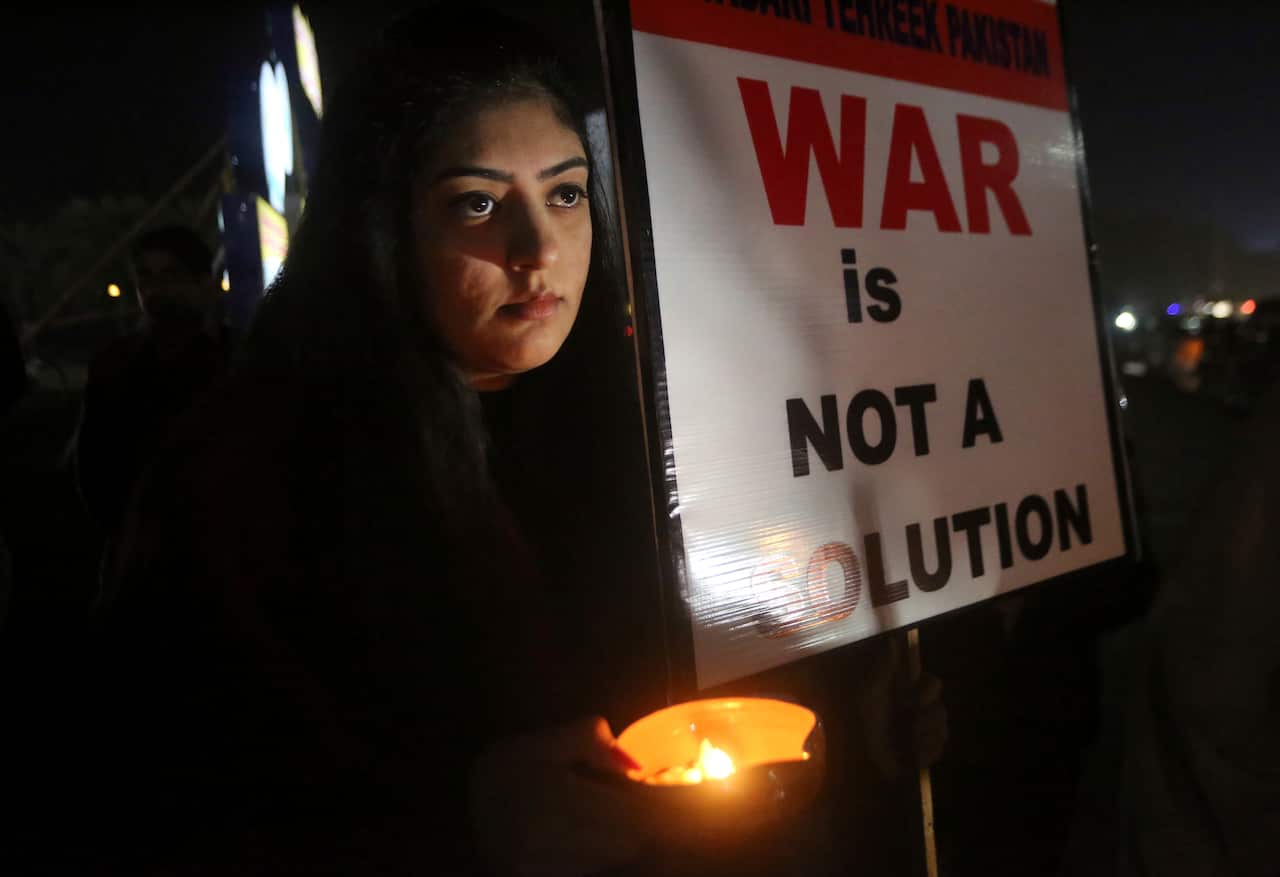A member of the civil society group, Citizens of Lahore, participates in a candlelit vigil against war, in Lahore, Pakistan.
