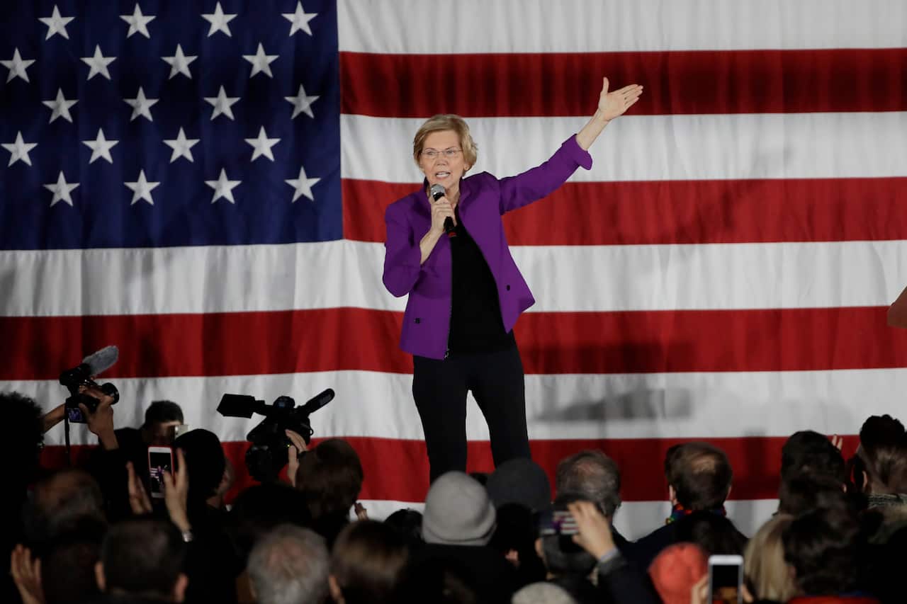 Elizabeth Warren with an American flag as her backdrop speaks to local supporters in New York.