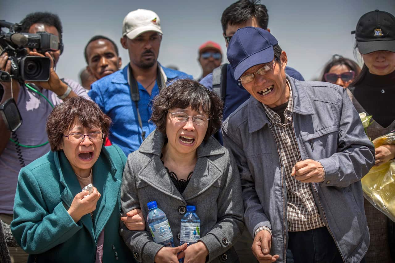Family members reacts at the scene where the Ethiopian Airlines Boeing 737 Max 8 crashed shortly after takeoff on Sunday.