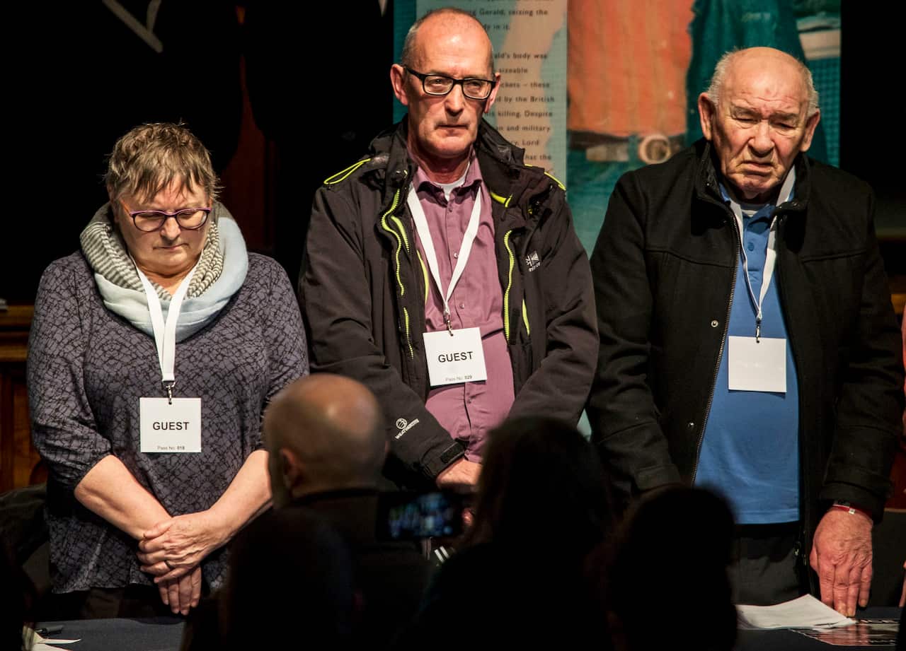 Jean Hegarty, sister of Kevin McElhinney, John Wray, brother of James Wray, and Paddy Nash, brother of William Nash, stand for a minute's silence.