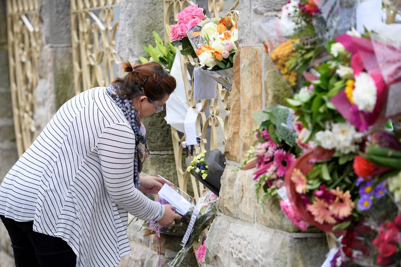 A woman places flowers outside the Lakemba Mosque, at Lakemba.