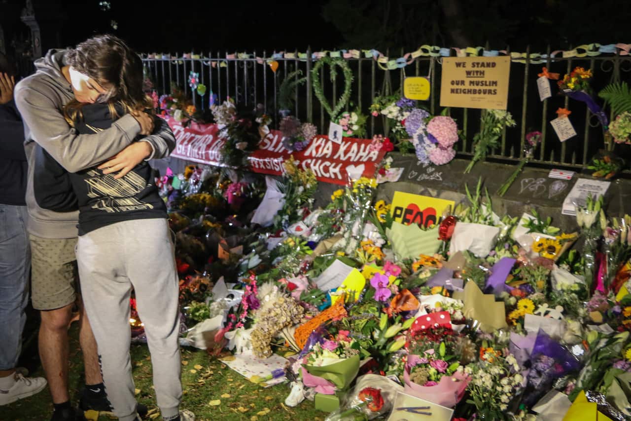 People seen comforting themselves while paying respect to the victims of the Christchurch mosques shooting.