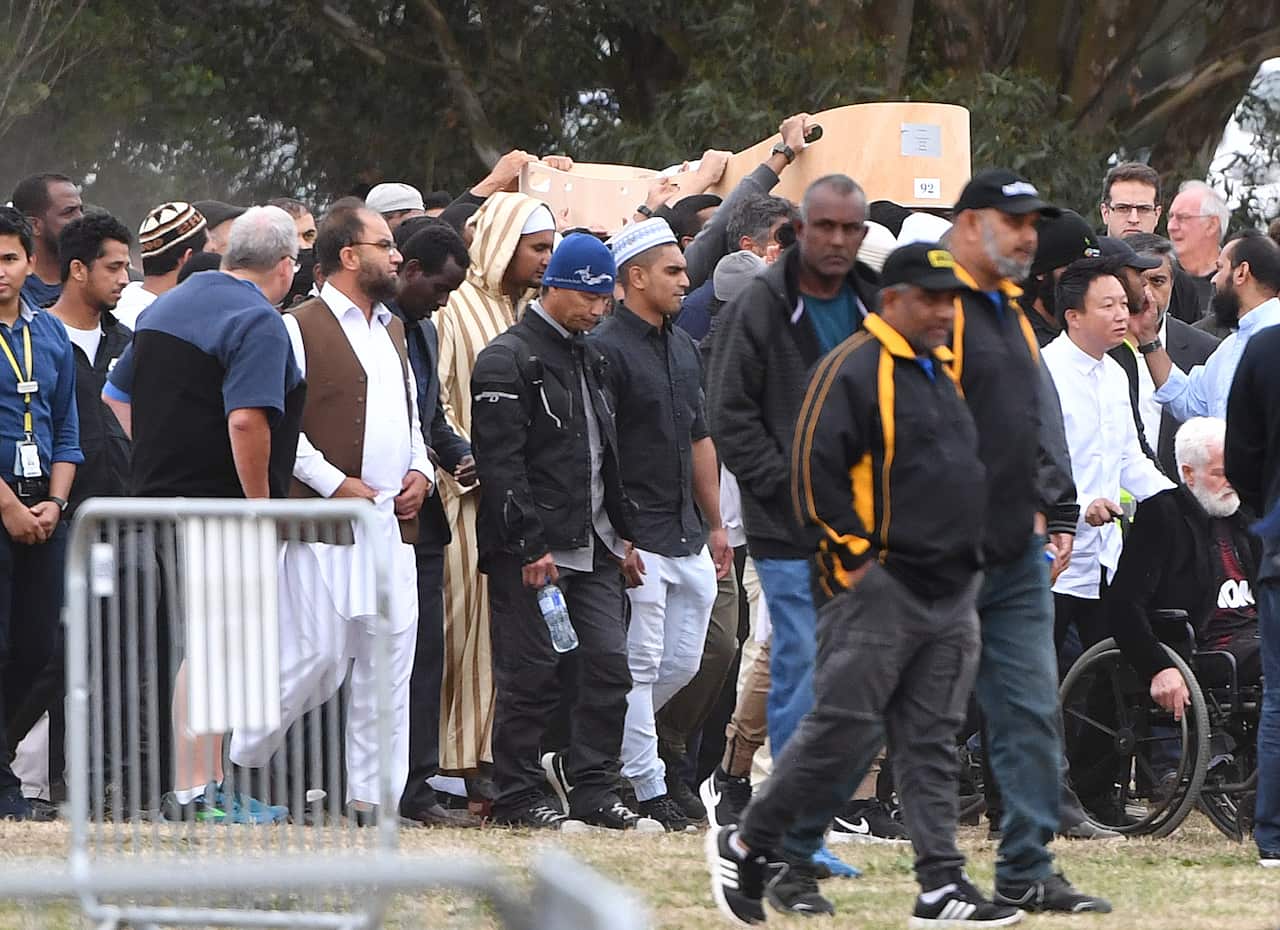 Mourners carry the casket of Sayyad Ahmed Milne, aged 14, at the Memorial Park Cemetery in Christchurch, New Zealand.