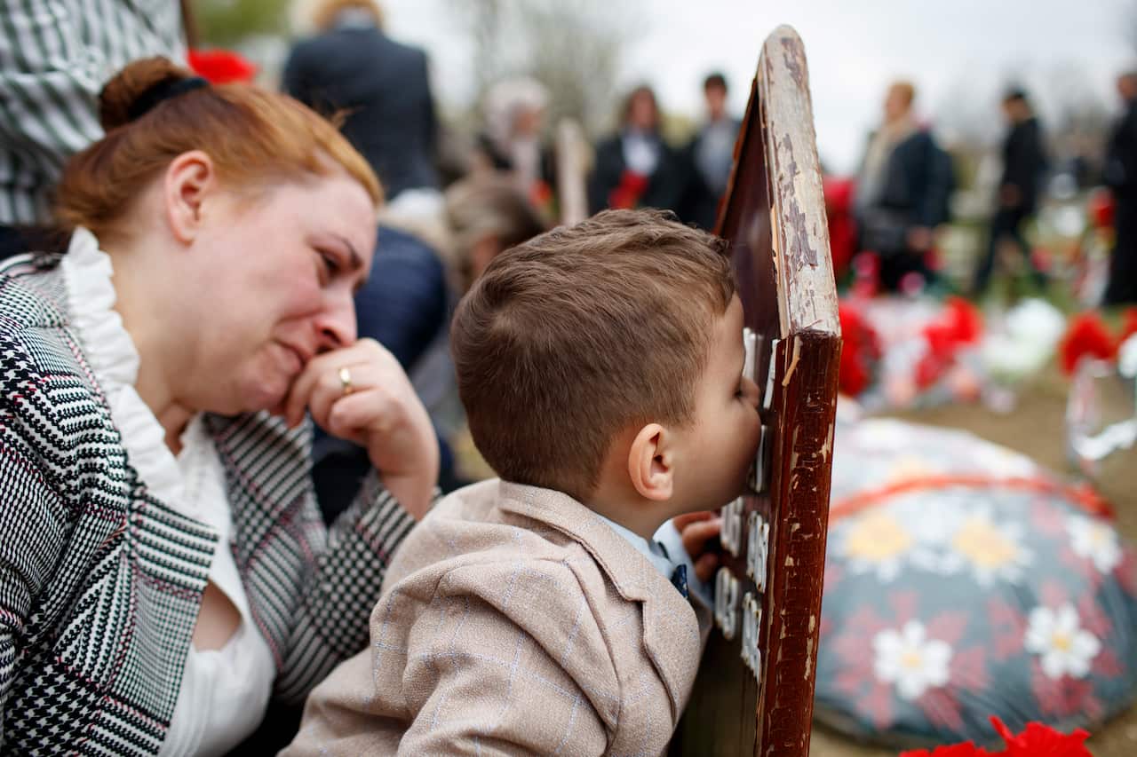 Kosovo Albanians mourn during the ceremony to mark the 20th anniversary of 113 men killed during the 1998-99 war in the village of Krusha e Vogel, Kosovo.