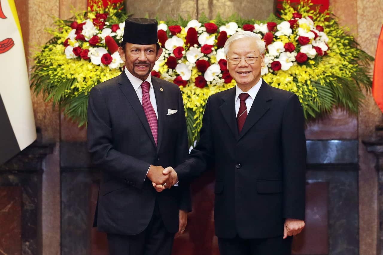 Sultan Haji Hassanal Bolkiah of Brunei shakes hands with Vietnam's President Nguyen Phu Trong.