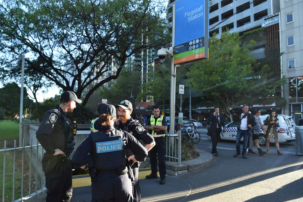 Victorian Police officerers guard an entrance to Flagstaff train station.