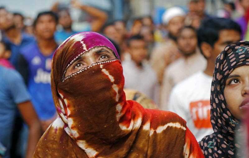 People watch the fire that broke out at a high-rise building in Banani area of Dhaka
