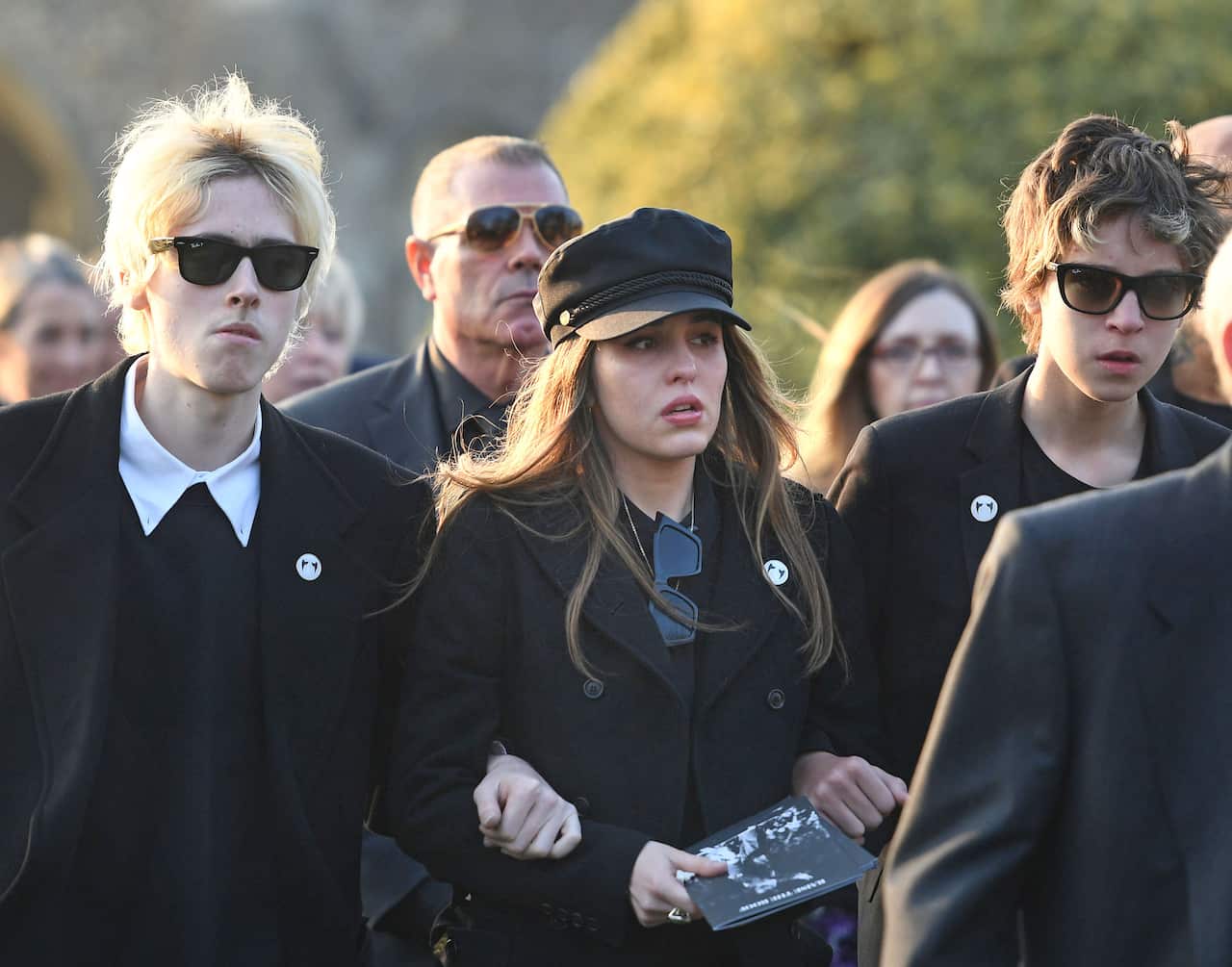 Gene Gallagher, Rachel Howlett and Ace Howlett after the funeral of Keith Flint at St Mary's Church in Bocking, Essex.
