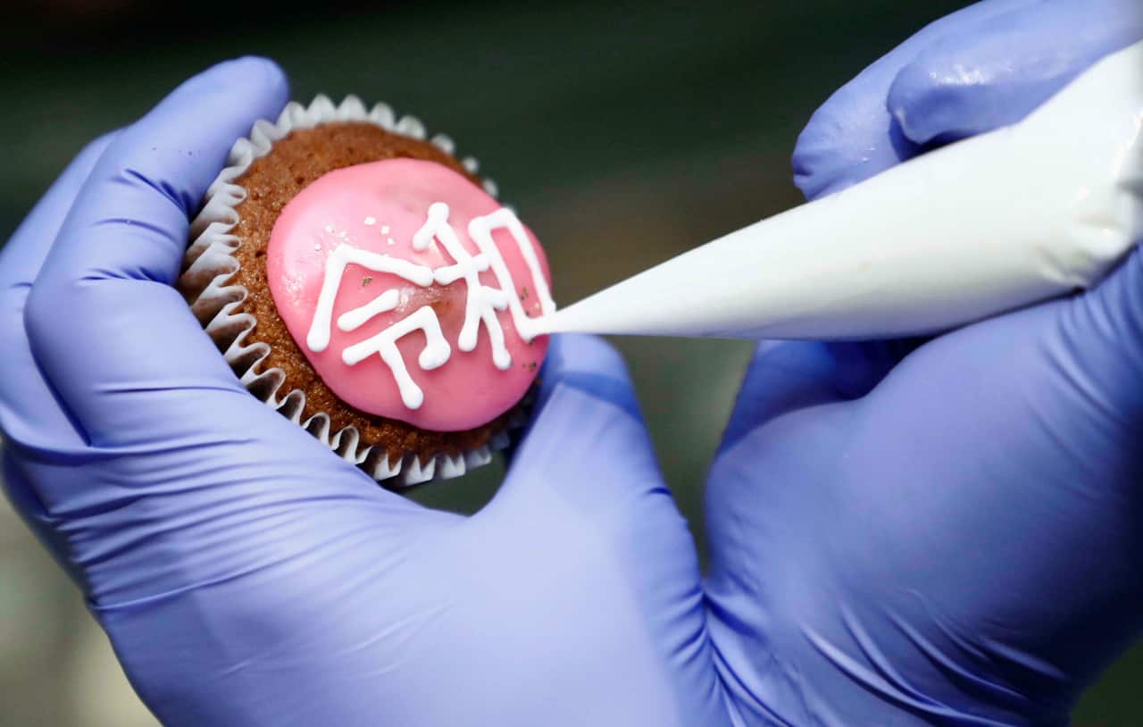 Photo taken at a cake fair at JR Tokyo Station on April 1, 2019, shows a cupcake decorated with the name of Japan's new era, "Reiwa," announced by the government earlier in the day. (Kyodo via AP Images) ==Kyodo