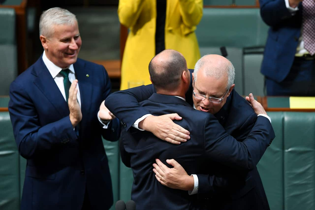 Australian Federal Treasurer Josh Frydenberg is congratulated by Australian Prime Minister Scott Morrison after the delivery of the 2019-20 Budget.