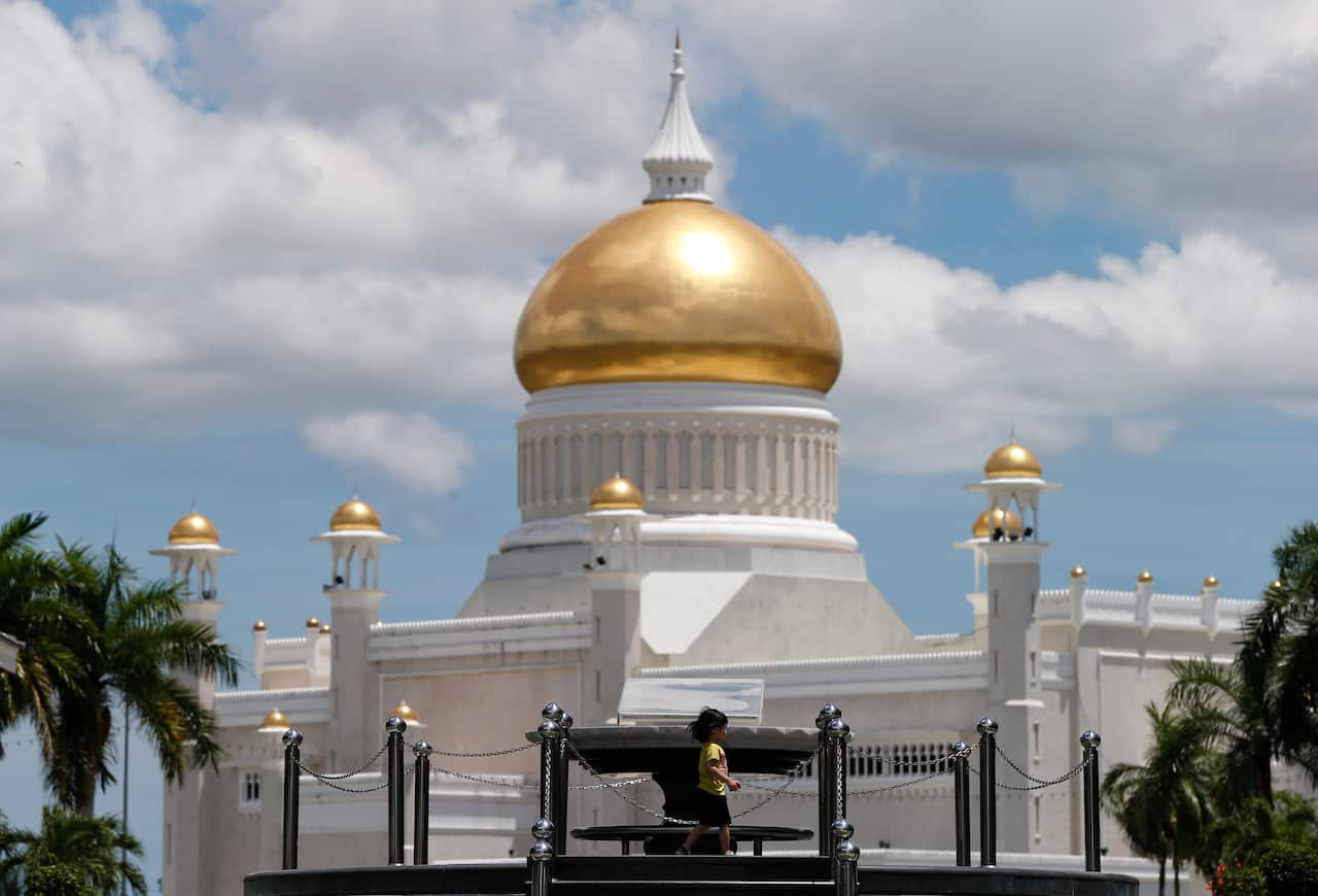 A children walks near Sultan Omar Ali Saifuddien Mosque, one of landmarks of Bandar Seri Begawan in Brunei.