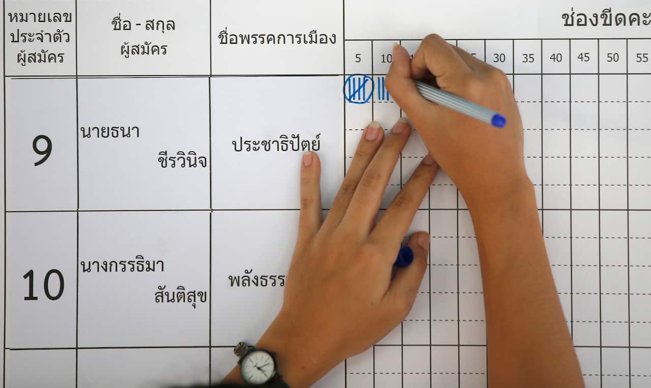 A Thai election officer marks vote count as counting commenced at a polling station in Bangkok earlier this year. 