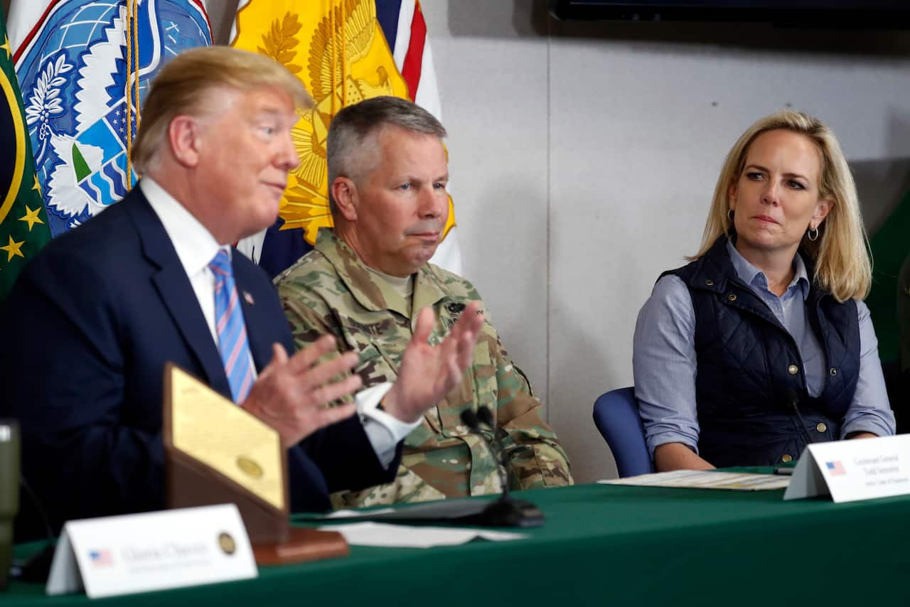 Lt. Gen. Todd Semonite, center, and Homeland Security Secretary Kirstjen Nielsen, listen as President Donald Trump participates in a roundtable on Saturday.