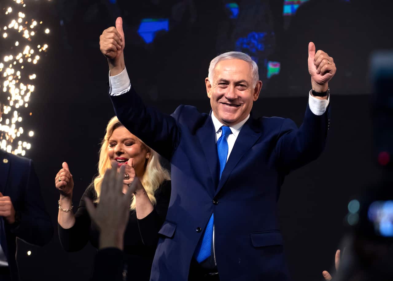 Israel's Prime Minister Benjamin Netanyahu and his wife Sarah gesture during a victory speech following the election in Tel Aviv, Israel, early 10 April 2019.