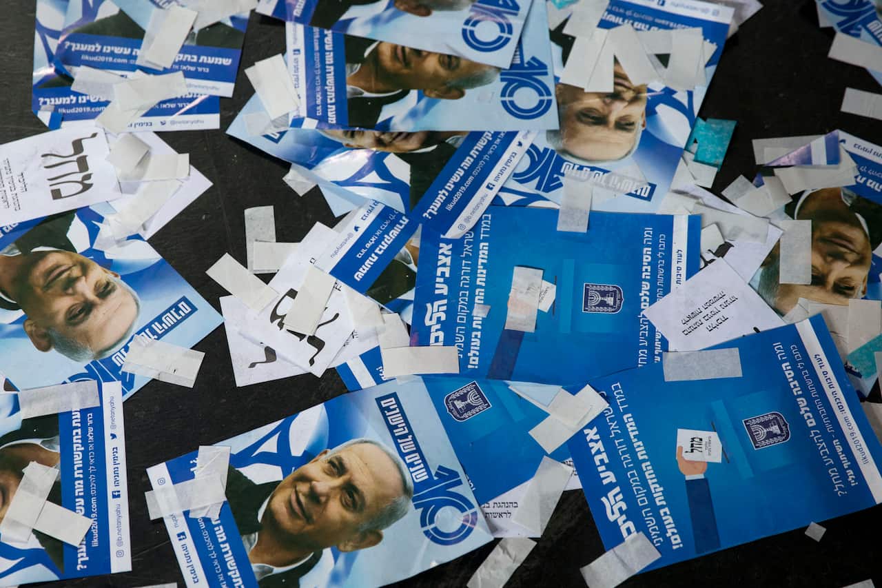 Likud party ballot papers and Israel's Prime Minister Benjamin Netanyahu's campaign fliers are seen on the ground after polls for Israel's general elections closed in Tel Aviv, Israel, Wednesday, April 10, 2019. (AP Photo/Ariel Schalit)