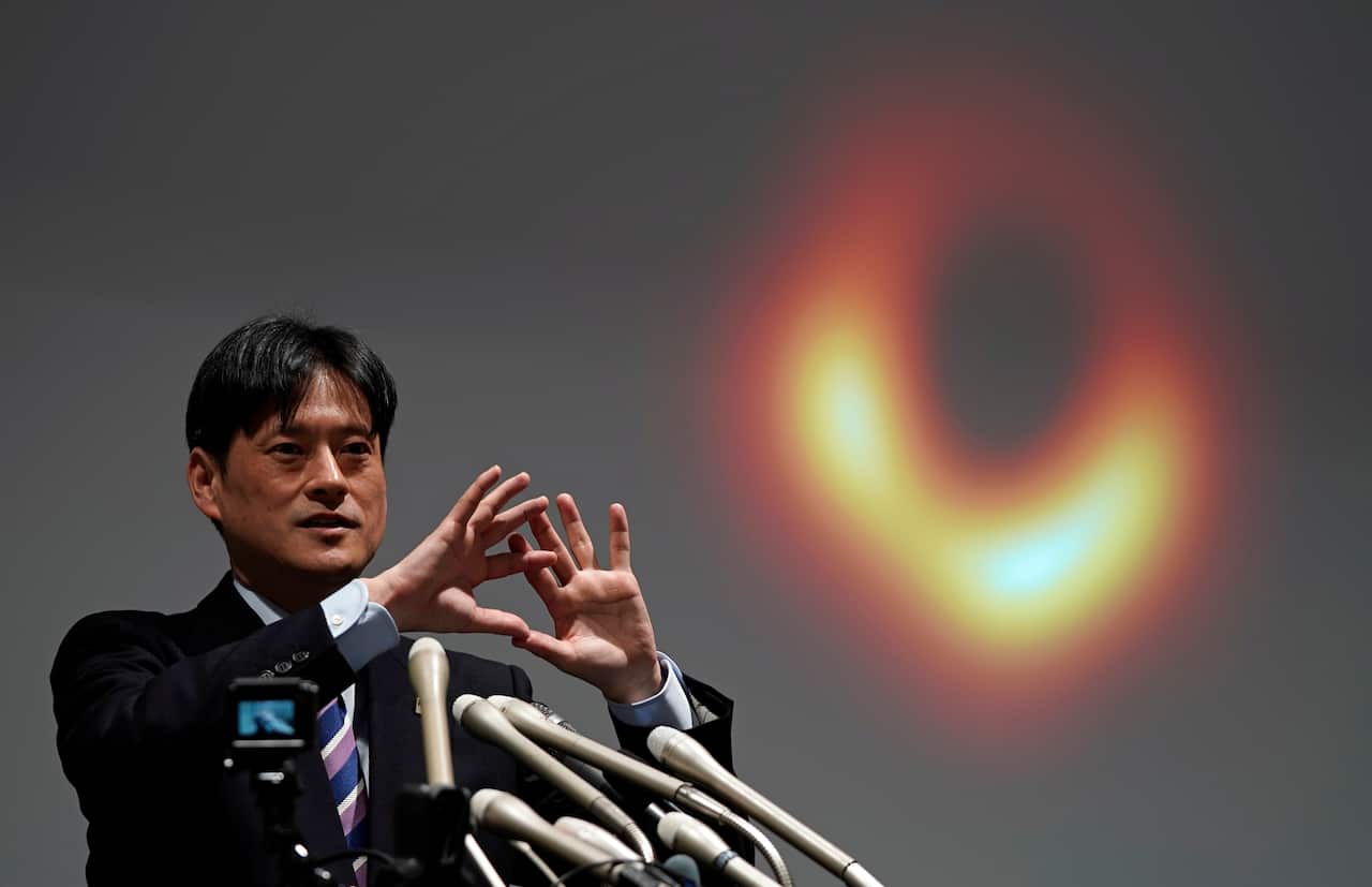 Mareki Honma of the National Astronomical Observatory of Japan unveils for the first time, the image of a black hole during a press conference in Tokyo, Japan.