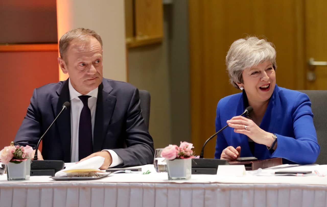 European Council President Donald Tusk, left, and British Prime Minister Theresa May meet with other EU leaders prior to a dinner during an EU summit.