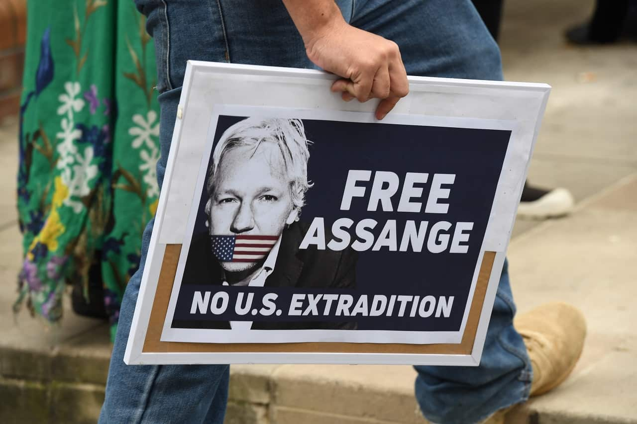 A supporter of Julian Assange and WikiLeaks holds a placard during a snap rally in Sydney.