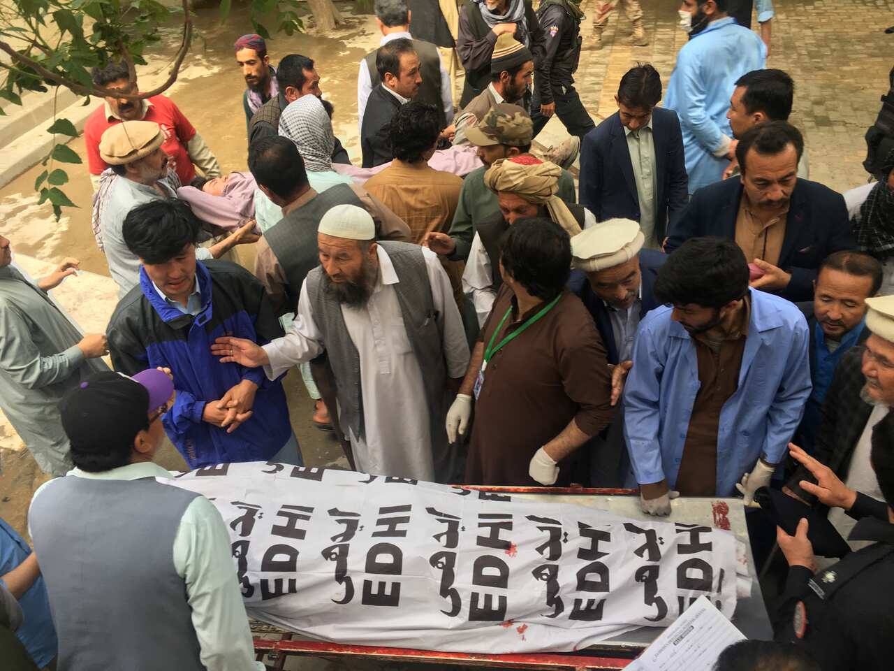 People shift the bodies of the victims of a bomb blast at a mortuary in Quetta, Pakistan.
