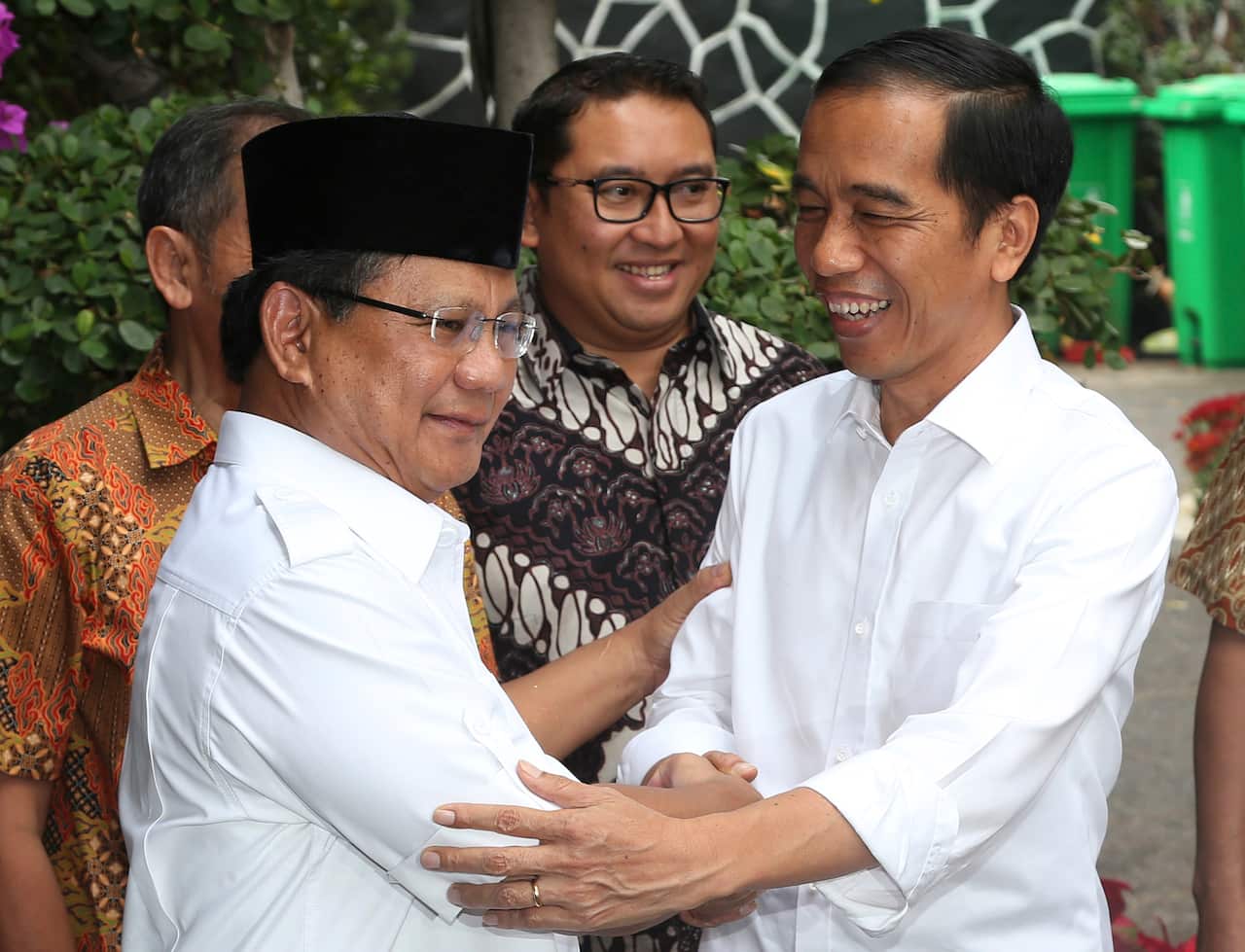 Indonesia's President-elect Joko Widodo, right, greets his political rival Prabowo Subianto during a meeting in Jakarta, Indonesia.