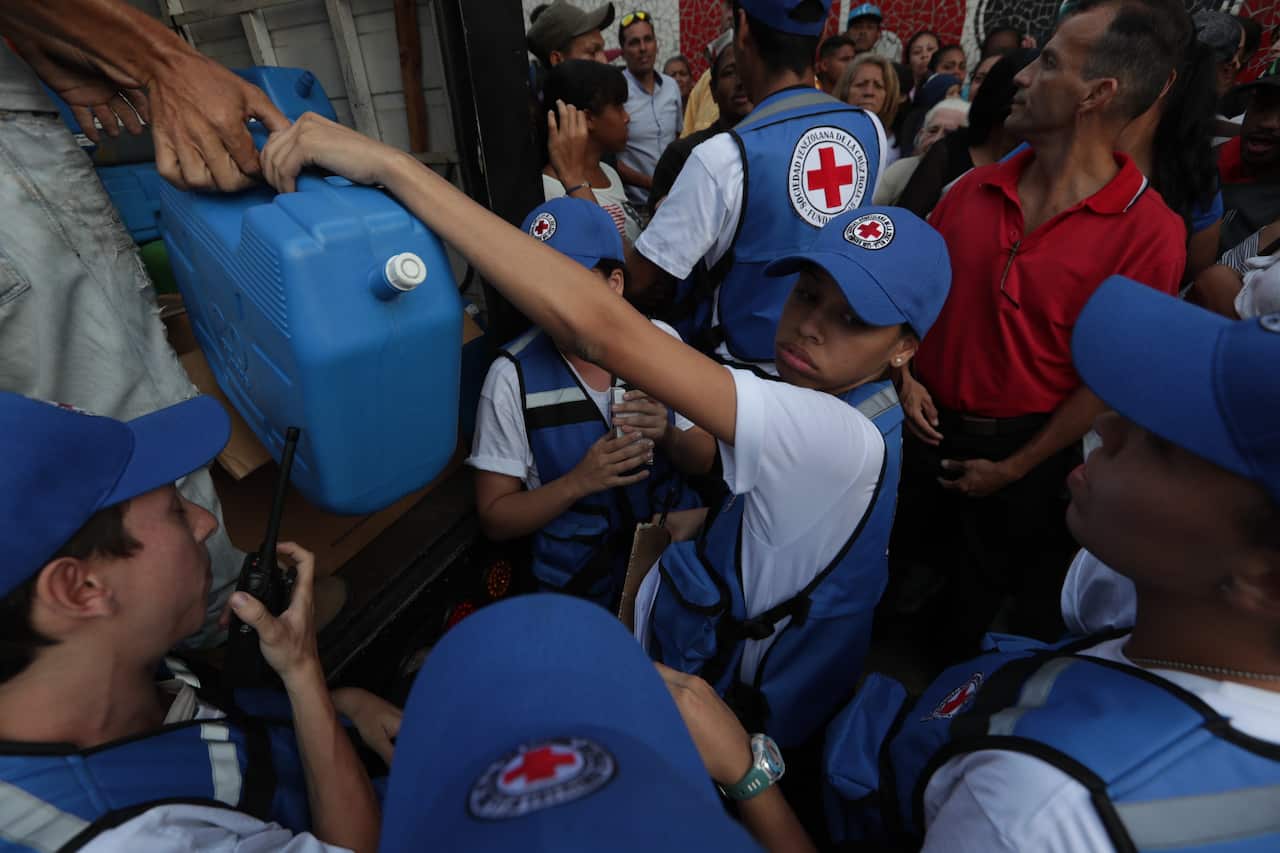 Members of the Red Cross distribute their first shipment of humanitarian aid in Caracas, Venezuela.